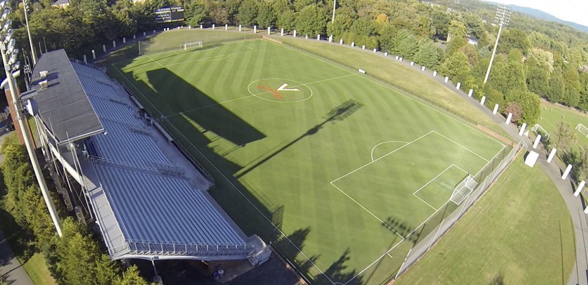 Klöckner Stadium at the University of Virginia with a green pitch and bleachers