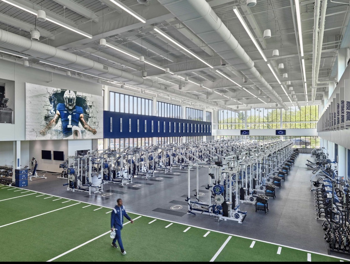 Penn State strength and conditioning weight room with rows of power racks