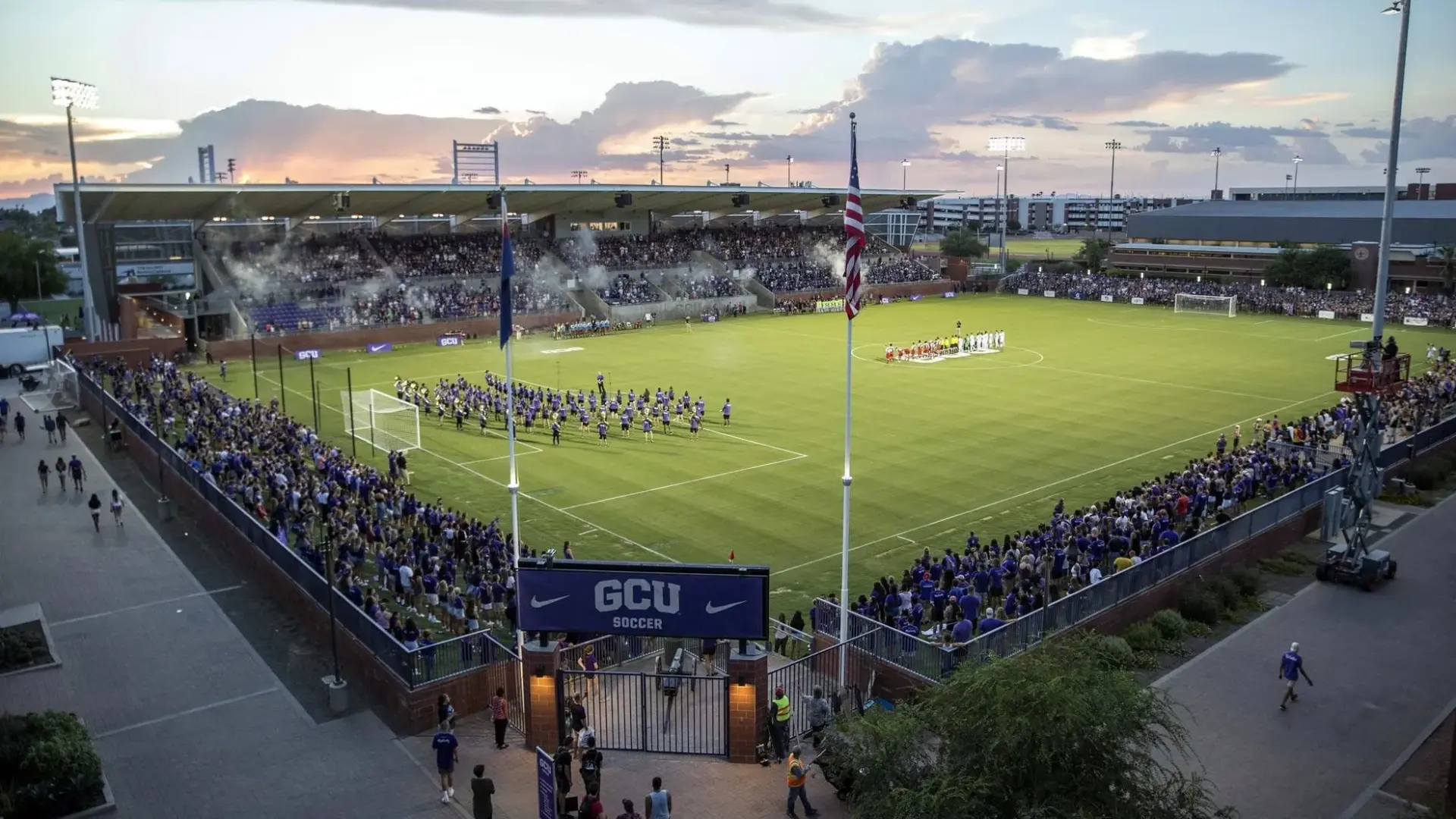 Grand Canyon University soccer stadium at dusk with a marching band on the pitch
